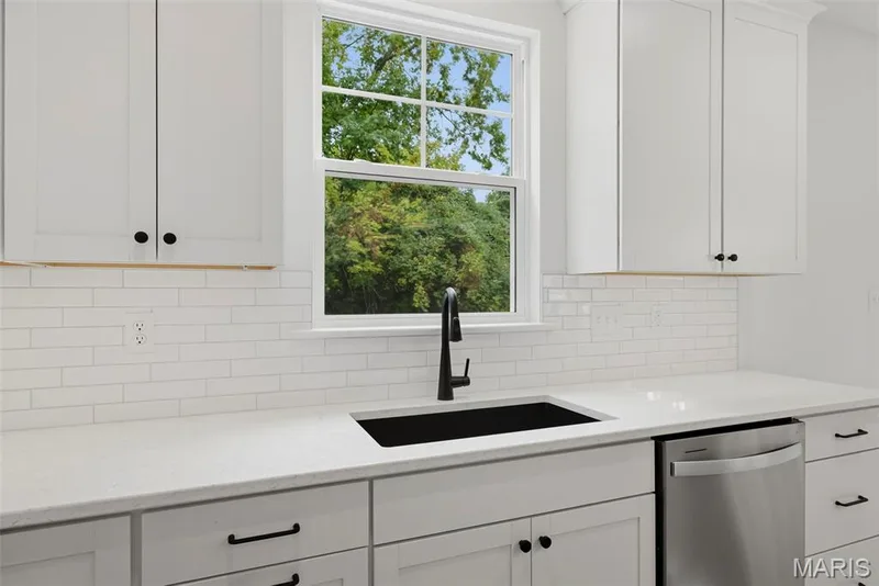 Window over Sink, Quartz Countertops, Tile Backsplash and Under Cabinet Lighting in Kitchen — 547 Ryehill Drive, St Peters, MO 63376