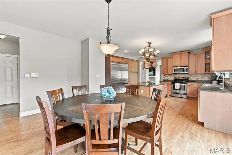 Open-concept kitchen and dining area — 1000 Gardenbridge Place, St Charles, MO 63303