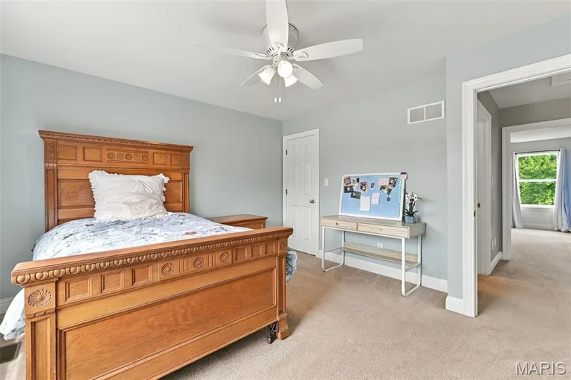 Neutral wall color with plush carpet flooring, white trim, and a ceiling fan with integrated lighting — 1000 Gardenbridge Place, St Charles, MO 63303
