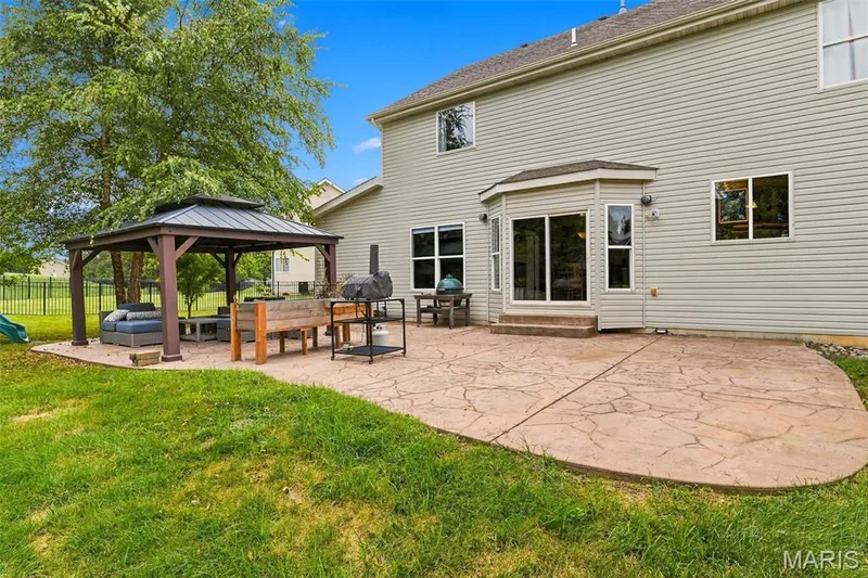 Expansive stamped concrete patio with a permanent gazebo — 1000 Gardenbridge Place, St Charles, MO 63303