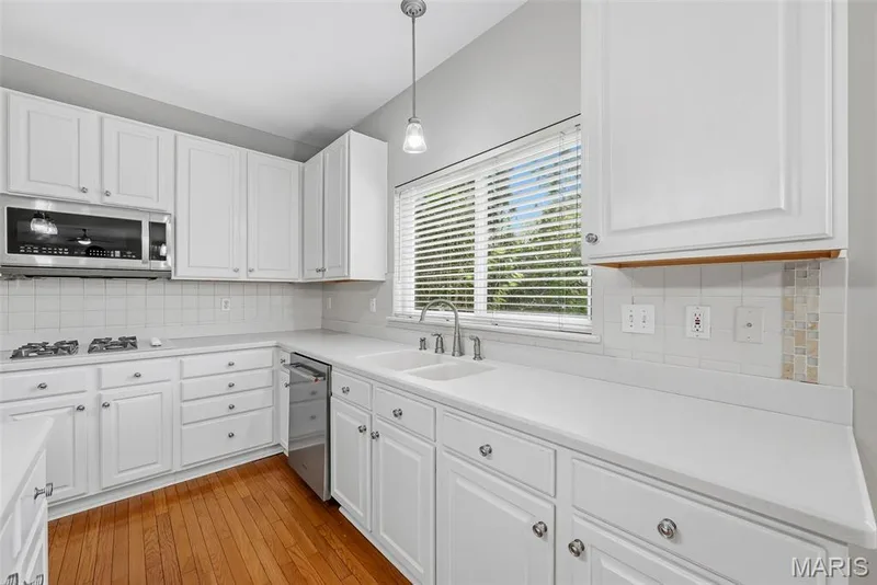 Solid Surface Countertops, Tile Backsplash and Stainless Steel Appliances in Kitchen — 223 Chestnut Hill Drive, O'Fallon, MO 63368