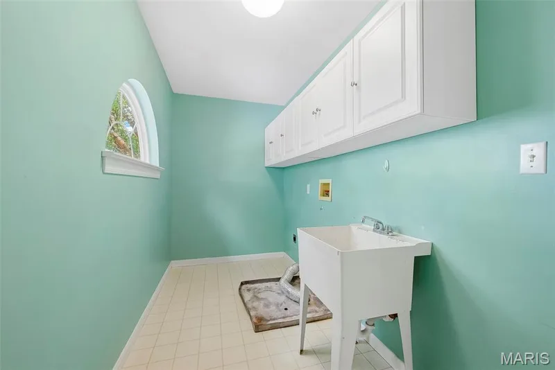 Laundry Room with Wash Sink and Wall Cabinets Conveniently Located on the Second Floor — 223 Chestnut Hill Drive, O'Fallon, MO 63368