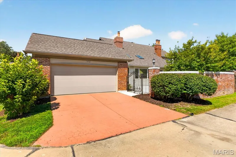 Brick exterior with an attached garage and a concrete driveway — 14418 W Open Meadow Court W, Chesterfield, MO 63017