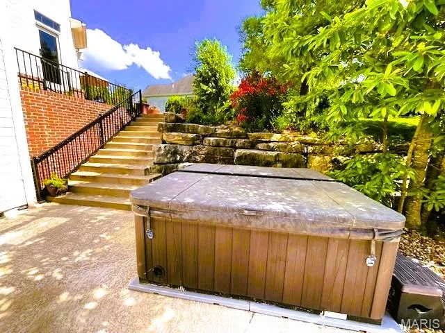 Scenic view of yard featuring a hot tub and stairway — 1009 Savonne Court, Chesterfield, MO 63005