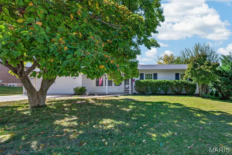 Mature trees and a spacious front lawn add to the home’s inviting curb appeal. — 2913 Cypress Drive, St Charles, MO 63301