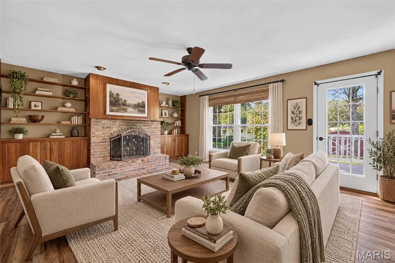 Virtually staged family room highlights the generous proportions, brick fireplace and built-in cabinetry. — 2913 Cypress Drive, St Charles, MO 63301