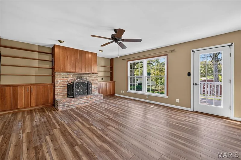 The family room addition offers a brick wood-burning fireplace, built-ins and abundant natural light. — 2913 Cypress Drive, St Charles, MO 63301