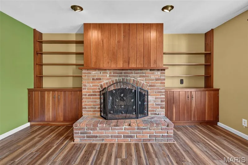 Brick fireplace and built-in cabinetry give the family room warmth and character. — 2913 Cypress Drive, St Charles, MO 63301