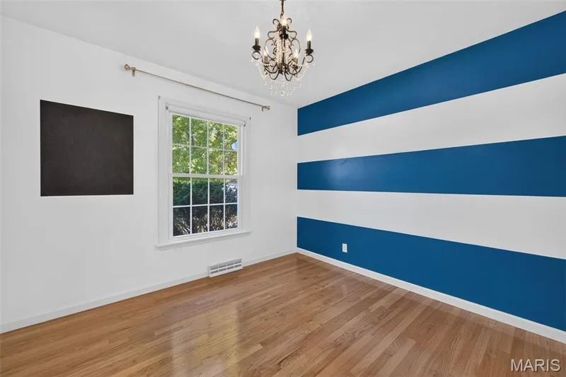 Third bedroom with hardwood flooring, natural light and fancy chandelier! — 2913 Cypress Drive, St Charles, MO 63301