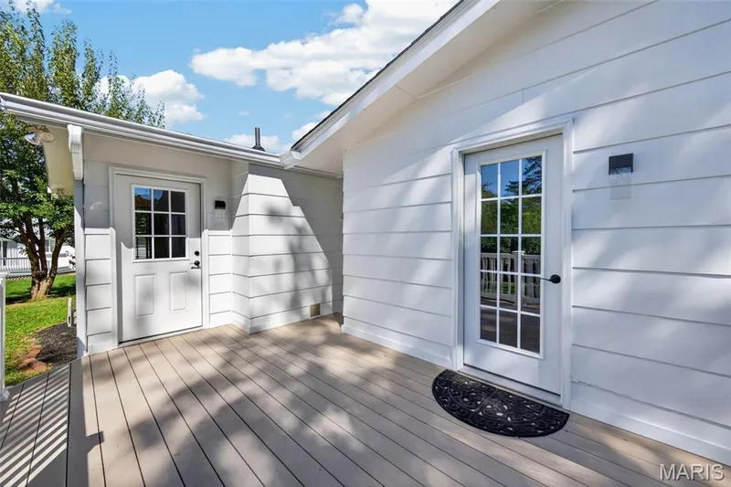 The deck connects multiple main-floor living spaces with the backyard. — 2913 Cypress Drive, St Charles, MO 63301