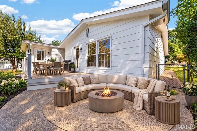 Virtually staged outdoor living areas illustrate furnishing possibilities for the existing deck and patio. — 2913 Cypress Drive, St Charles, MO 63301