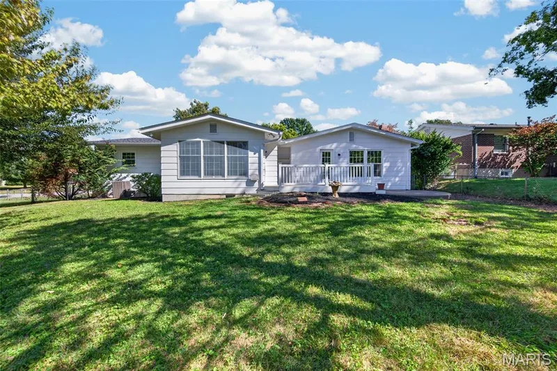 Rear view highlights the home’s expanded living space, deck and patio. — 2913 Cypress Drive, St Charles, MO 63301