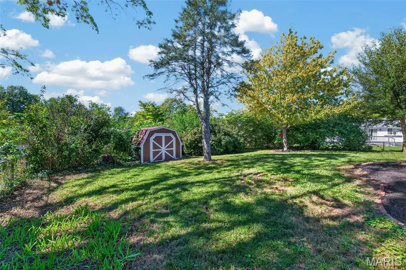 Another look across the backyard, including the storage shed. — 2913 Cypress Drive, St Charles, MO 63301