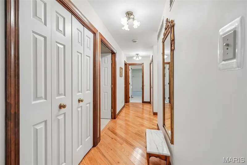 Hallway leading to bedrooms with large coat closet on left — 2260 Ridgley Woods Drive, Chesterfield, MO 63005