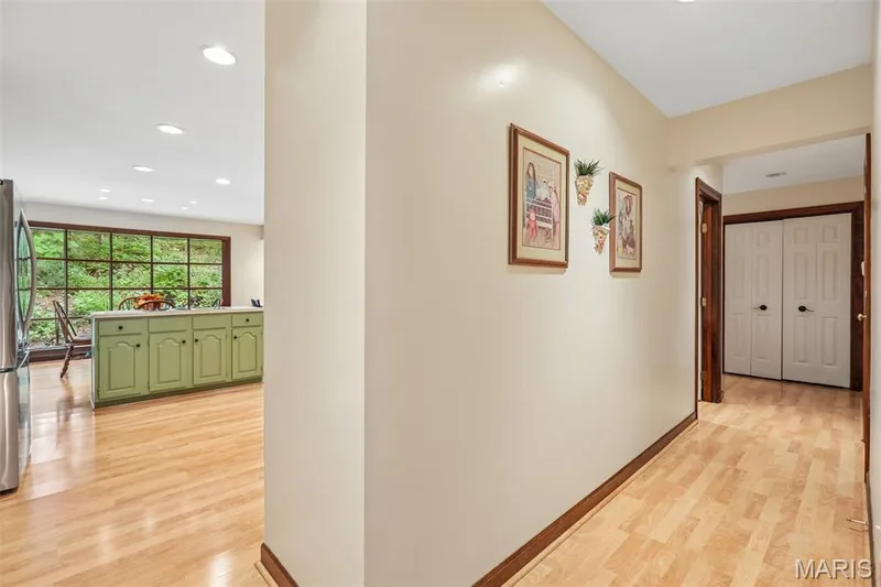 Hall leading to garage, half bath, and laundry room — 2260 Ridgley Woods Drive, Chesterfield, MO 63005