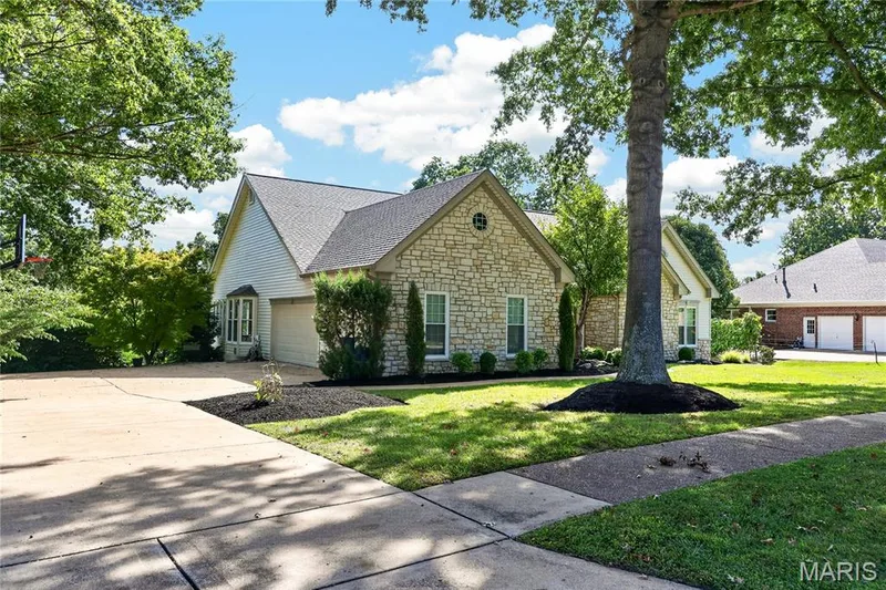 Stone and siding exterior with a gabled roof — 17711 Birch Leaf Court, Chesterfield, MO 63005