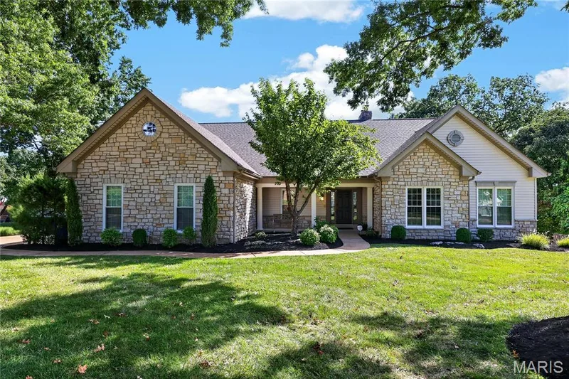 Stone and siding exterior with a gabled roofline and multiple windows — 17711 Birch Leaf Court, Chesterfield, MO 63005