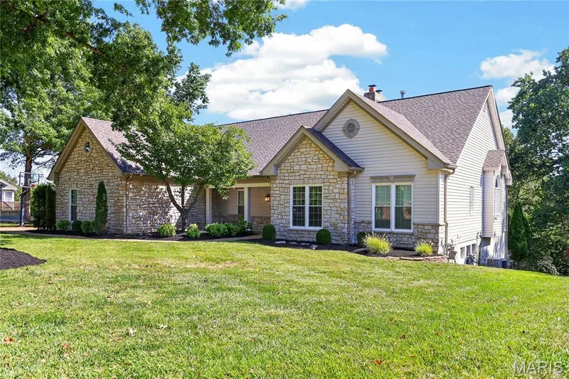 Stone and siding exterior with gabled roofline and multiple windows — 17711 Birch Leaf Court, Chesterfield, MO 63005