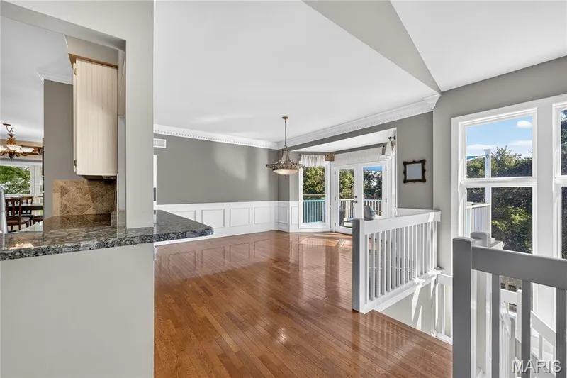 Hardwood flooring, crown molding, wainscoting, French doors, and a stone-finish countertop — 17711 Birch Leaf Court, Chesterfield, MO 63005