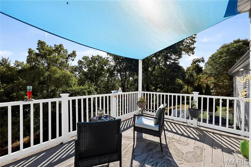 Outdoor deck with a shade sail, white railing, and composite decking — 17711 Birch Leaf Court, Chesterfield, MO 63005