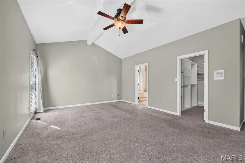 Vaulted ceiling with an attached ceiling fan, carpeted flooring, and organized built-in closet shelving — 17711 Birch Leaf Court, Chesterfield, MO 63005