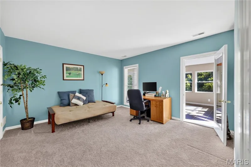 Light gray carpeting throughout, light blue painted walls, white trim, and a doorway with French doors — 17711 Birch Leaf Court, Chesterfield, MO 63005