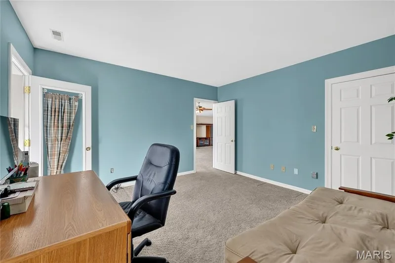Neutral tone wall paint, light-colored carpeting, multiple paneled doors, and a built-in wall niche — 17711 Birch Leaf Court, Chesterfield, MO 63005