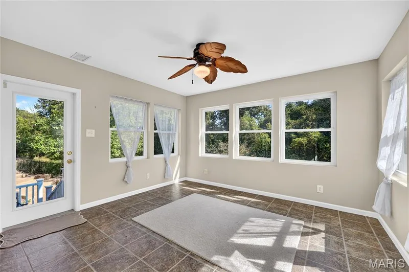 Tiled flooring complemented by multiple windows and a ceiling fan — 17711 Birch Leaf Court, Chesterfield, MO 63005