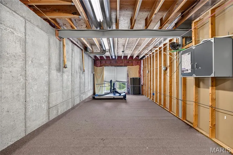 Unfinished space featuring exposed ceiling joists, concrete foundation walls, and framed interior walls — 17711 Birch Leaf Court, Chesterfield, MO 63005