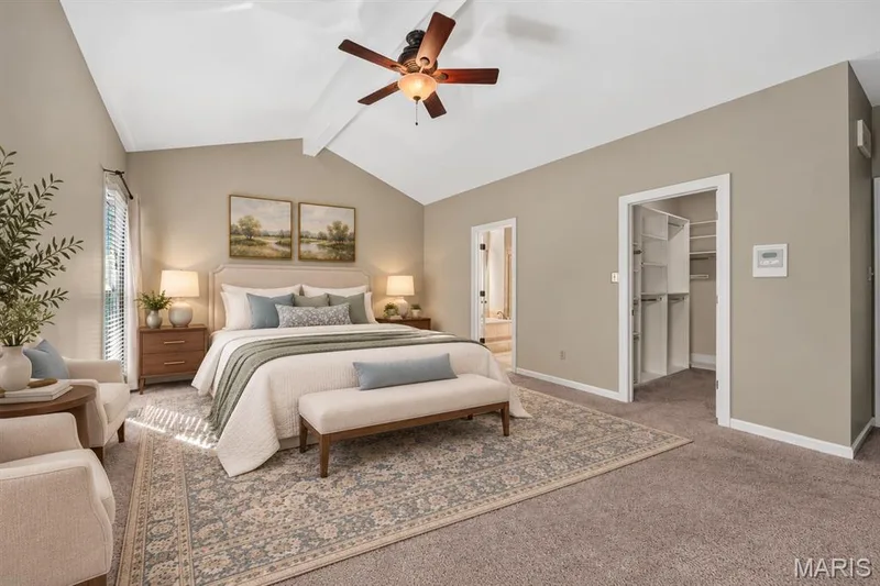 Vaulted ceilings featuring a central ceiling fan and neutral wall finishes, paired with carpeted flooring and a built-in closet system — 17711 Birch Leaf Court, Chesterfield, MO 63005