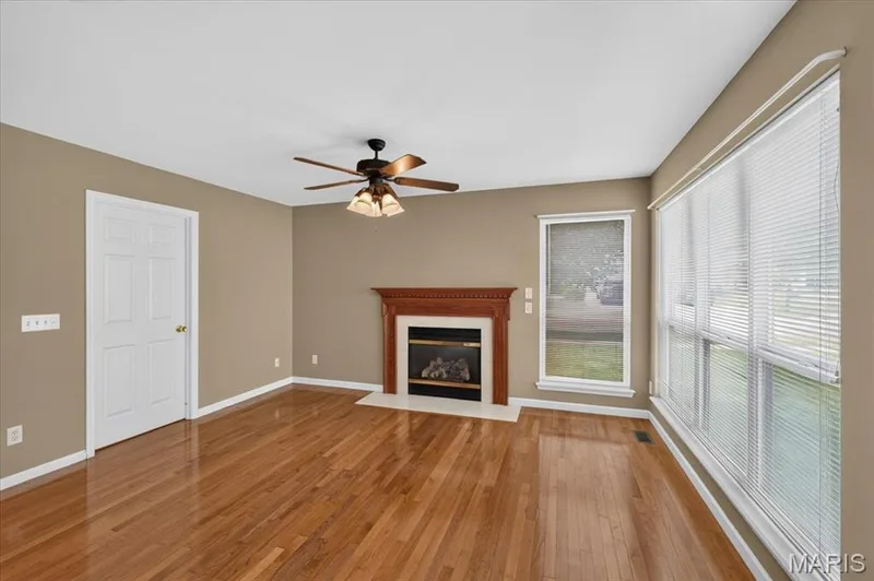 Living room has fireplace and opens to the laundry room. — 11 Swift Creek Court, St Peters, MO 63376