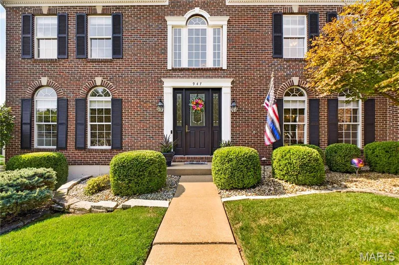 Front door is oversized and features leaded glass windows. — 947 Crown Pointe Estates Drive, Wildwood, MO 63021