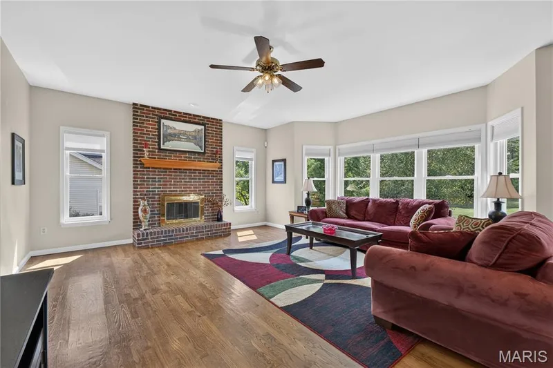Family room has gas fireplace, large bay window, entrance to deck and wet bar. — 947 Crown Pointe Estates Drive, Wildwood, MO 63021
