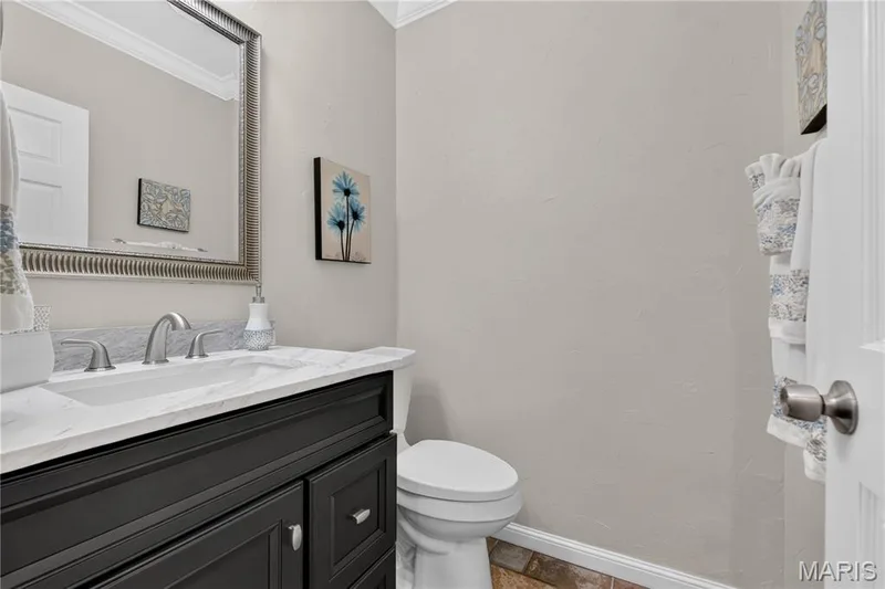 Main floor half bath has been updated with newer vanity, lighting and mirror. — 947 Crown Pointe Estates Drive, Wildwood, MO 63021