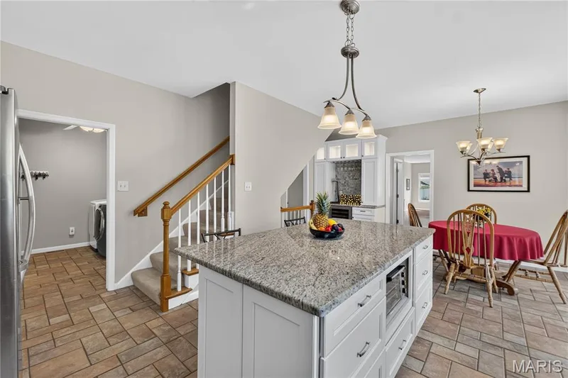 The rear staircase leads to the upper level. — 947 Crown Pointe Estates Drive, Wildwood, MO 63021