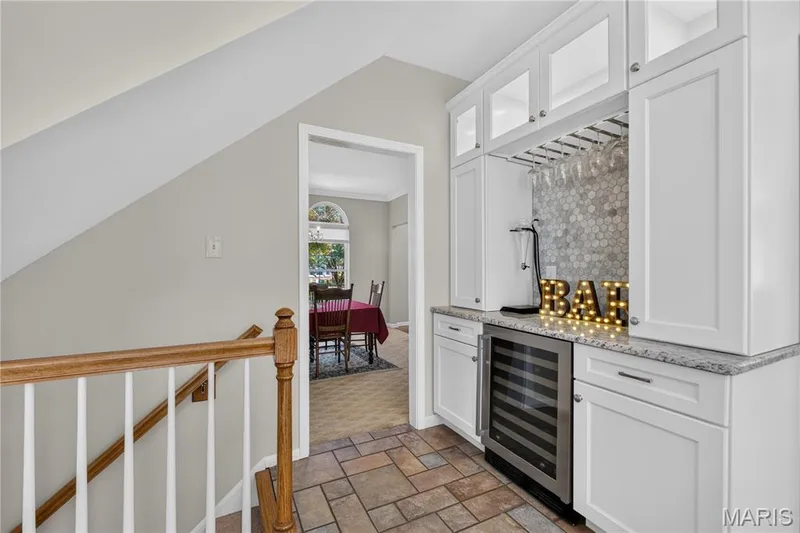 Beautiful wine bar features wine cooler, granite counters, wine glass rack and lighted cabinets. — 947 Crown Pointe Estates Drive, Wildwood, MO 63021