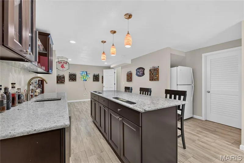 Recessed lighting, plus pendant lights over the bar creates a wonderful ambiance. — 947 Crown Pointe Estates Drive, Wildwood, MO 63021