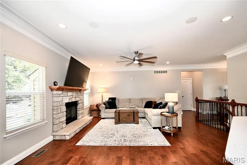 Living room with hardwood floors and gas fireplace. — 412 Cottage Grove Drive, Wentzville, MO 63385