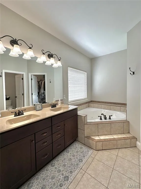 Primary bath with walk-in closet. — 412 Cottage Grove Drive, Wentzville, MO 63385