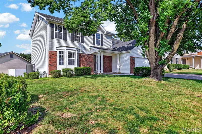 Two-story residence featuring light-colored siding and brick accents — 39 Green Pines Circle, St Peters, MO 63376