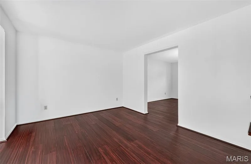 Dark wood-finish flooring with white walls and trim throughout — 39 Green Pines Circle, St Peters, MO 63376