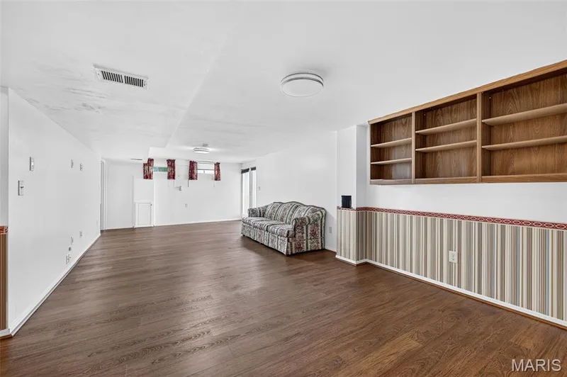 Wood-finish flooring, built-in shelving, recessed lighting, and wall paneling — 39 Green Pines Circle, St Peters, MO 63376