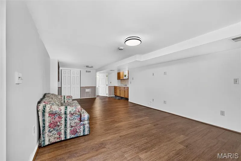 Spacious room featuring wood-finish flooring, recessed lighting, and a kitchenette with wood cabinetry — 39 Green Pines Circle, St Peters, MO 63376