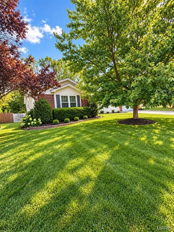 Expansive front lawn with a manicured finish, virtually staged landscaping — 3 Fairfax Drive, St Peters, MO 63376