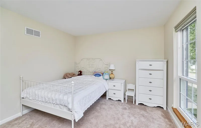 Warm-toned walls with a large window — 16500 Victoria Crossing Drive, Wildwood, MO 63040