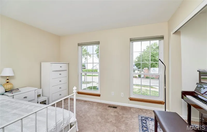 Warm neutral wall color, two large windows, wood-finish window sills, and carpeted flooring — 16500 Victoria Crossing Drive, Wildwood, MO 63040