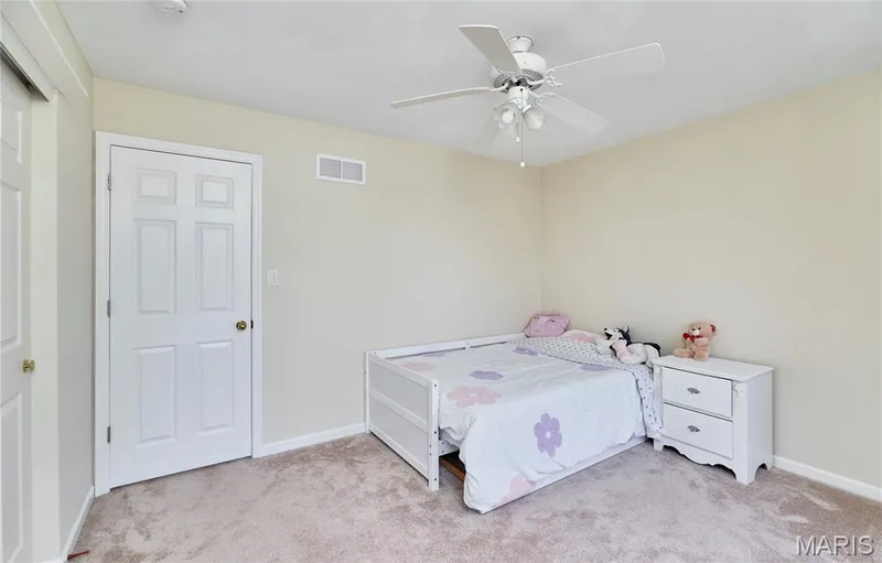 Plush carpet flooring, neutral painted walls, and a ceiling fan with integrated lighting — 16500 Victoria Crossing Drive, Wildwood, MO 63040