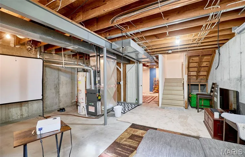 Concrete flooring, exposed ceiling joists, and a partial staircase — 16500 Victoria Crossing Drive, Wildwood, MO 63040