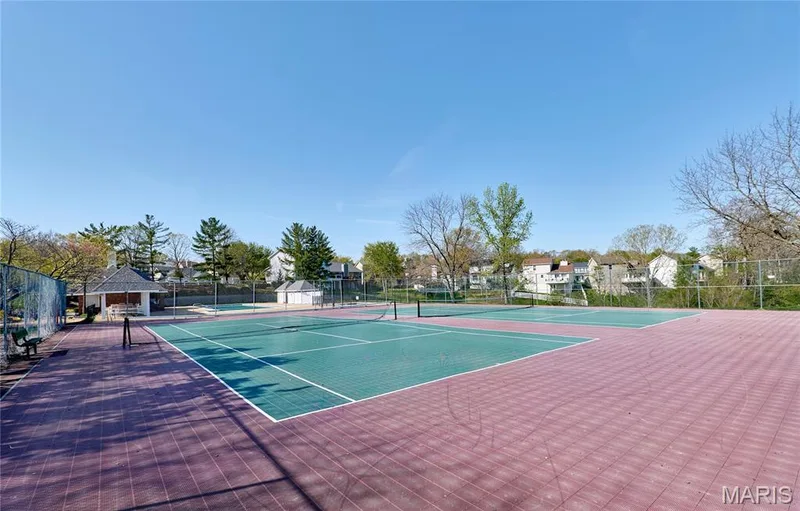 Tennis court facility featuring two courts, a covered pavilion, and surrounding fencing — 16500 Victoria Crossing Drive, Wildwood, MO 63040
