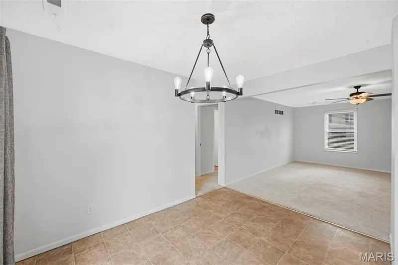 Open floor plan from breakfast room to living room — 773 Delray Drive #D, St Peters, MO 63376